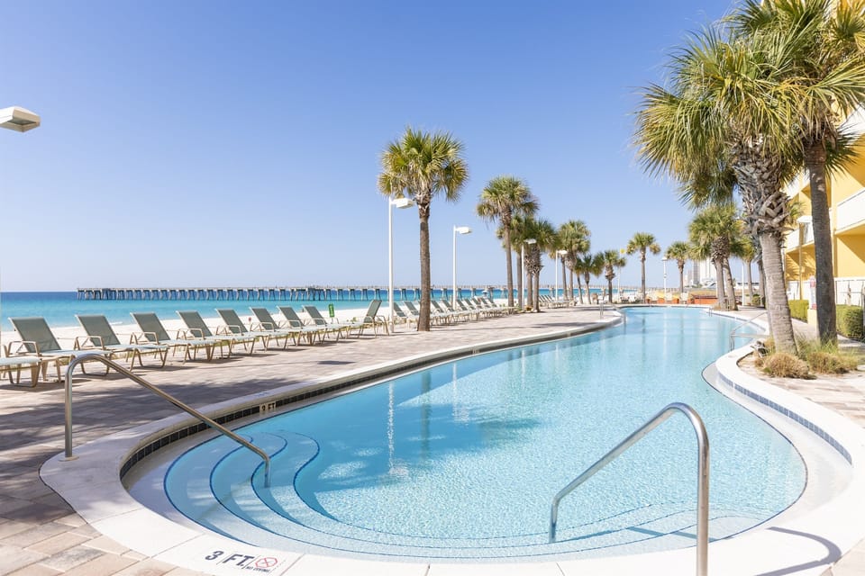 Dive into paradise at this stunning beachfront pool, where crystal-clear waters meet white sand beaches and swaying palms create your tropical escape.