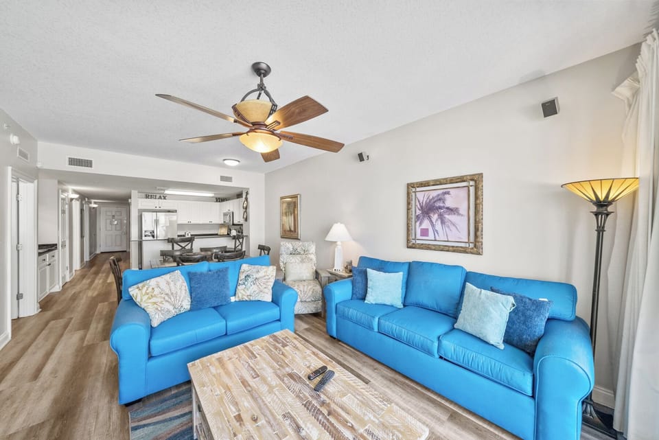 Sink into plush blue sofas in your bright, airy living room where coastal comfort meets modern style, perfect for relaxing after beach days.