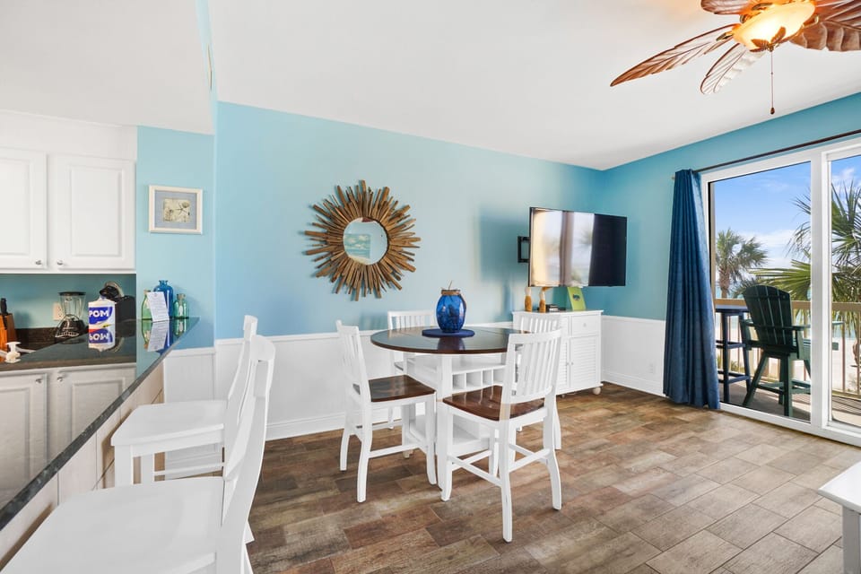 Enjoy meals in your bright coastal dining space with ocean breezes flowing through sliding doors to your private balcony.