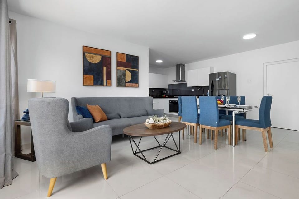 Unwind in style in this bright and airy open-plan living area! With a plush, oversized couch, there's plenty of space for the whole family to lounge, chat, and create unforgettable memories.