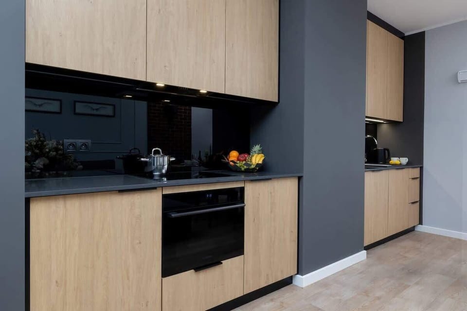 Kitchenette with oven and refrigerator. 