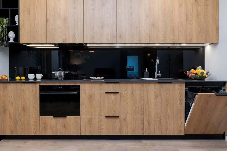 The same kitchen as described earlier, viewed from a different angle, showcasing the wooden countertop and contemporary style.