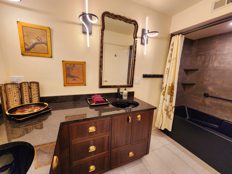 Updated 2024. Lower Level Guest Bathroom. Double Sinks, Tub/Shower