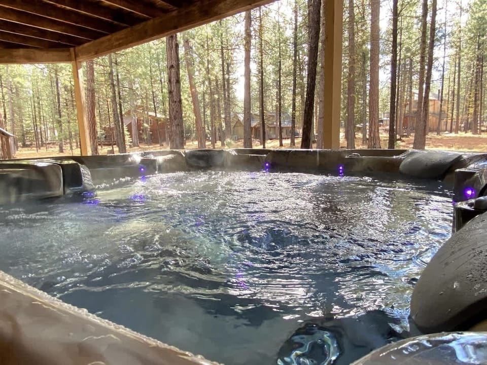 The hot tub comfortably seats 6 adults and is located under the deck.