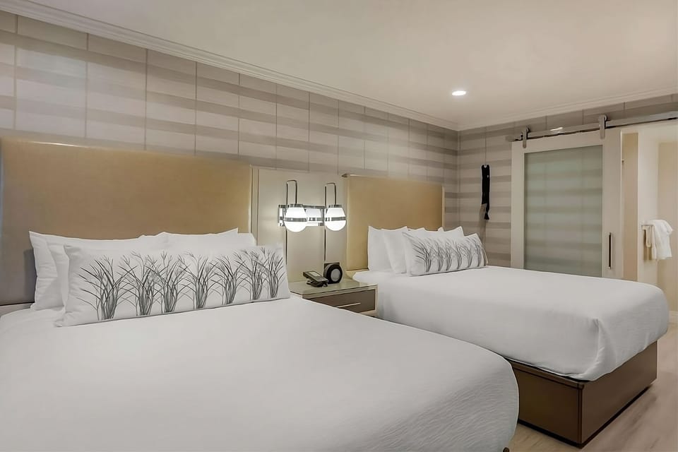 Stretch out on crisp linens under warm, ambient bedside lighting.