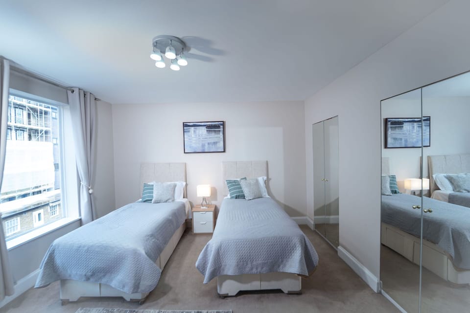 Double bedroom with mirrored wardrobe and ceiling fan