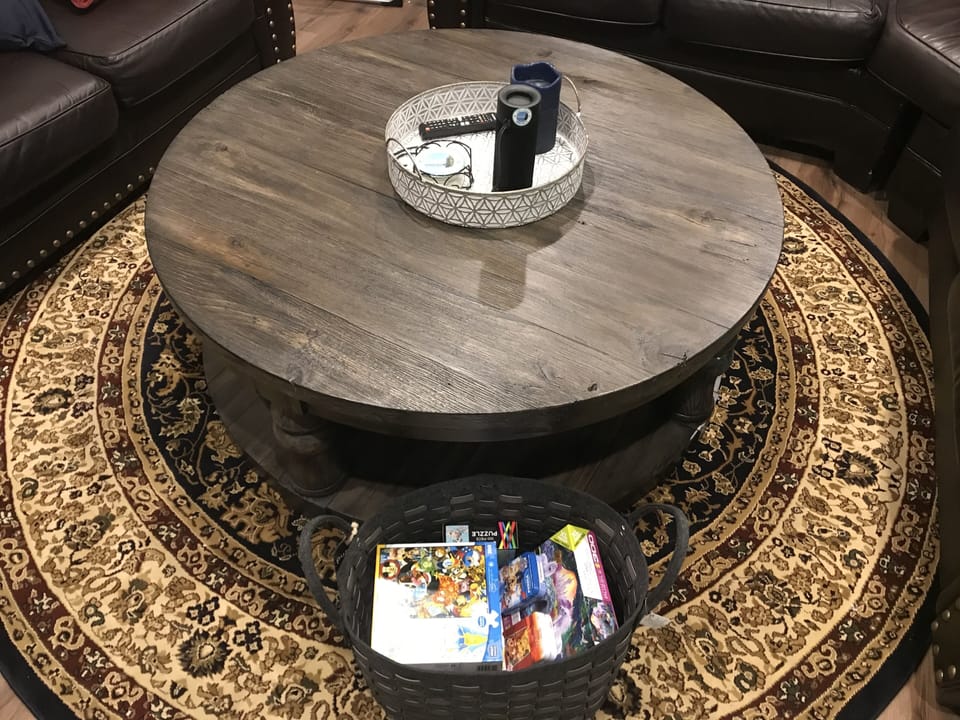 Family room coffee table with basket of puzzles stored underneath