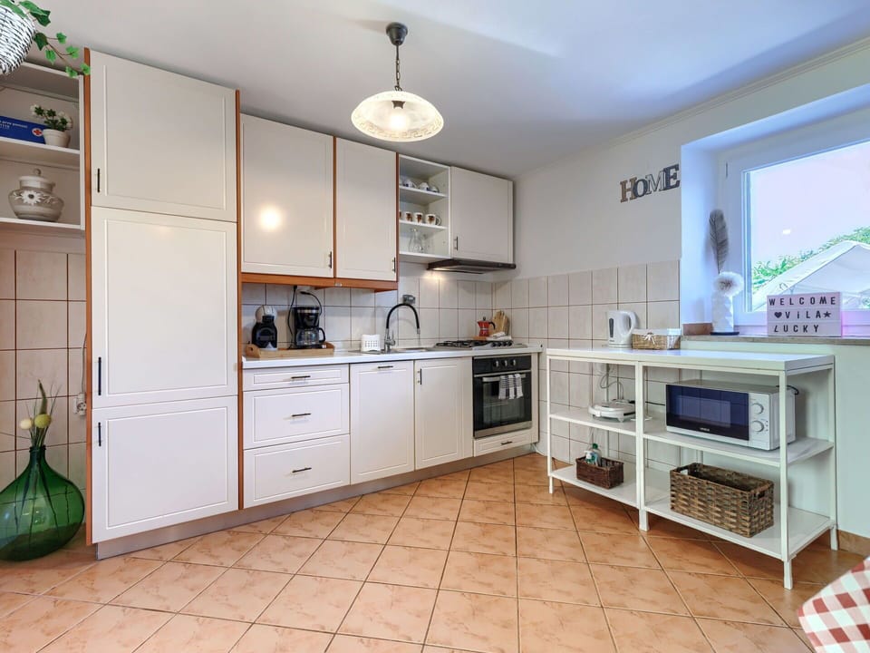 Kitchen, Kitchen Appliance, Cabinetry, Countertop, Major Appliance, Flooring, Interior Design, Wood, Floor, Cupboard