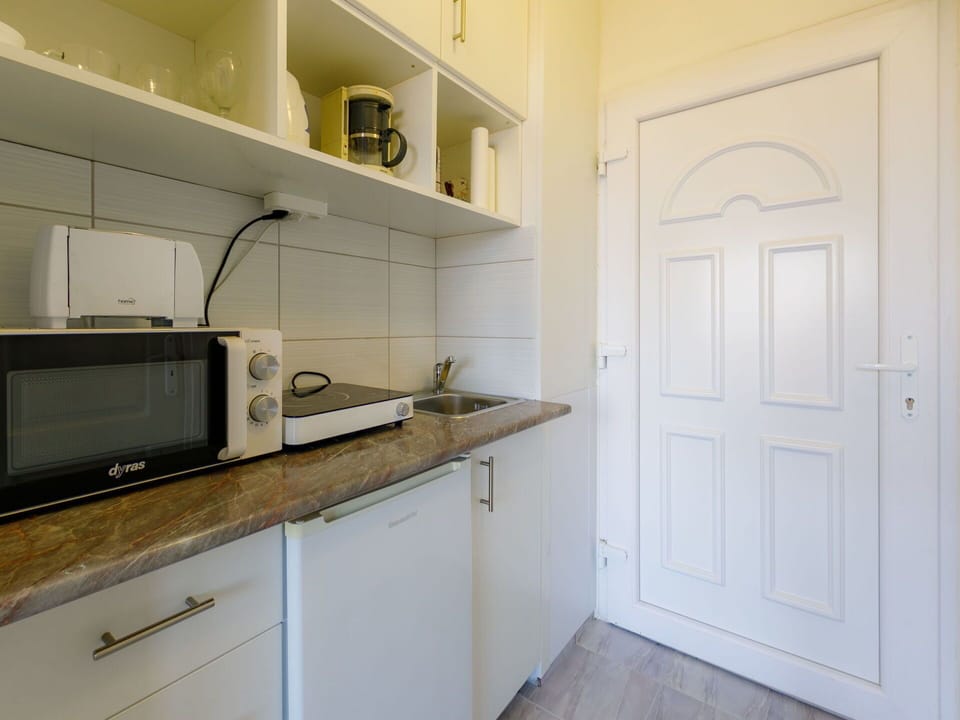 Room, Property, Kitchen, Cabinetry, Countertop, Furniture, Interior Design, Building, Yellow, Floor