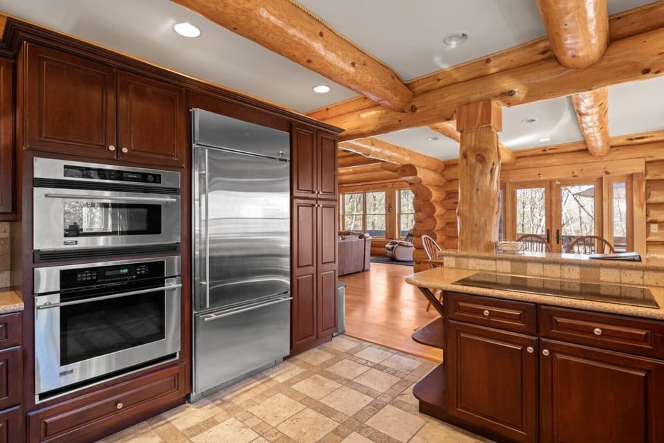 Large refrigerator with drawer freezer, oven, microwave, dishwasher, toaster oven, cooktop electric stove, Keurig and drip coffee makers.