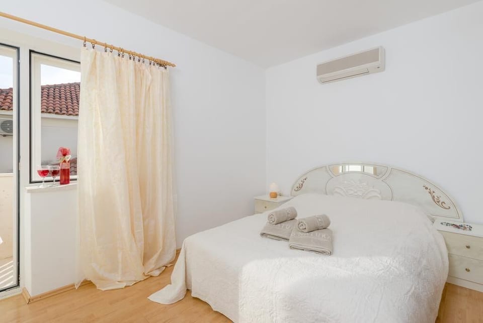Bedroom of Podstrana luxury pool villa with the king size bed and private balcony with sea view for family vacation