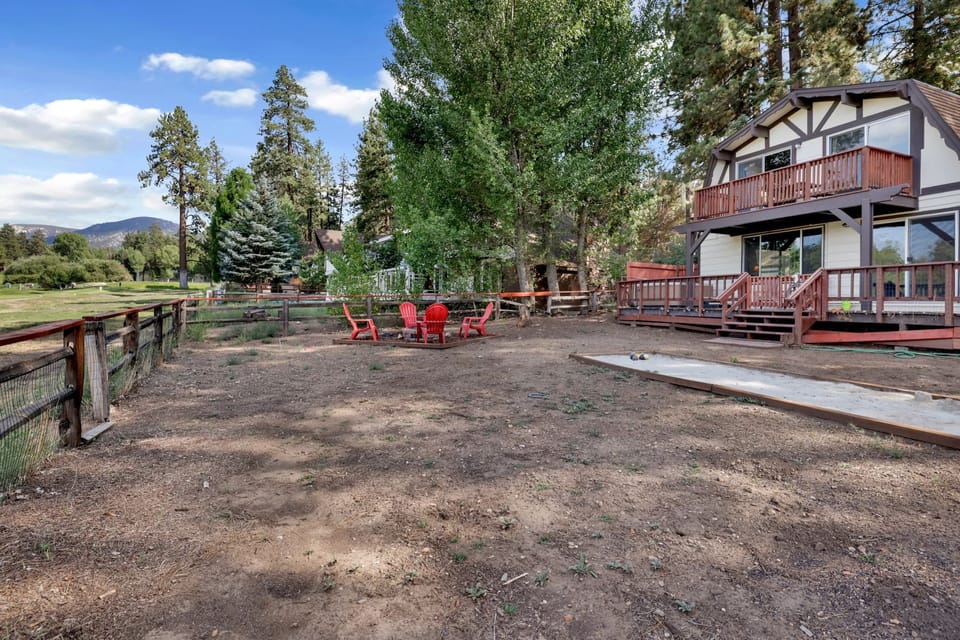 Private outdoor backyard surrounded by tall pines, perfect for relaxing under the trees after a day of adventure—enjoy peaceful forest views, fresh air, and a truly rejuvenating stay.