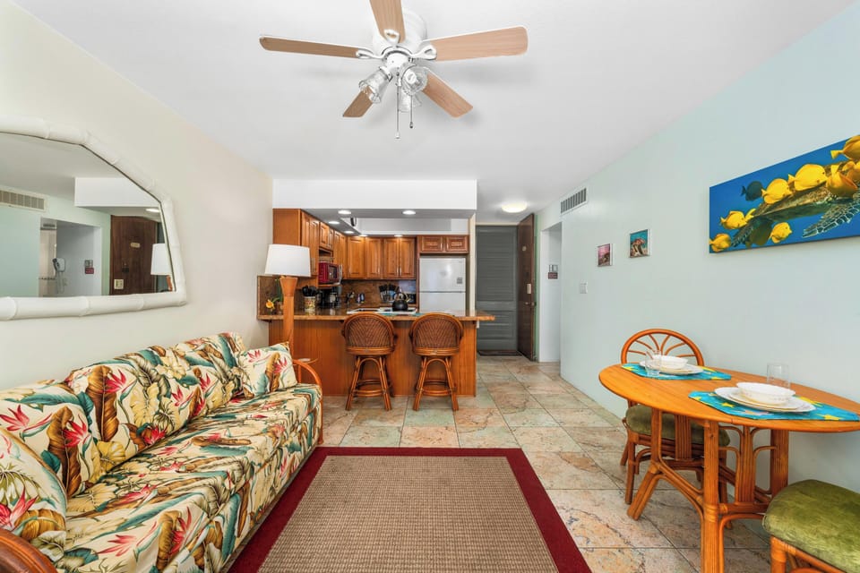 Relax in a bright living area with a comfortable sofa bed, central A/C, and direct access to the lanai with ocean panoramas.