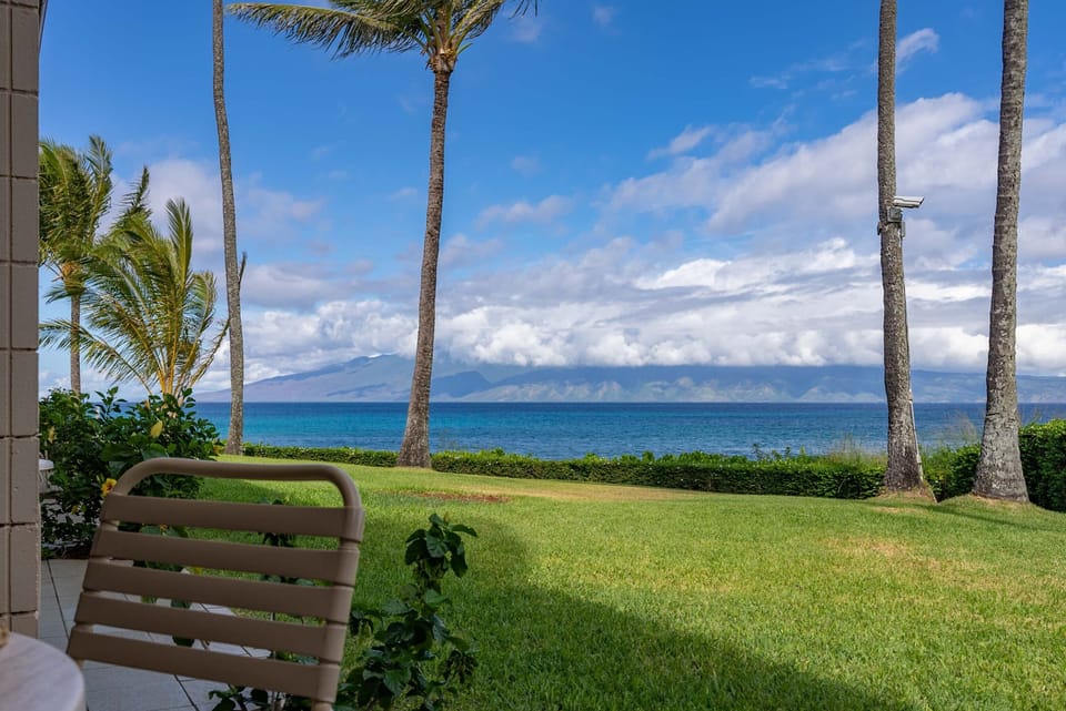 your view from the private lanai - Step out into this beautifully kept lawn, coconut trees, Moloka'i in the background and the ocean.