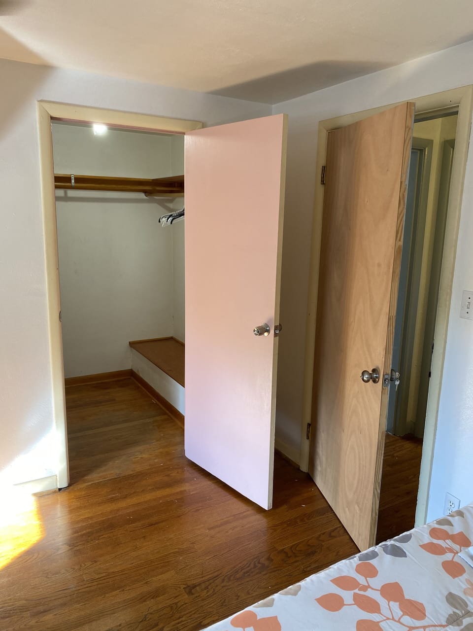 Large walk in closet in bedroom with full size bed 