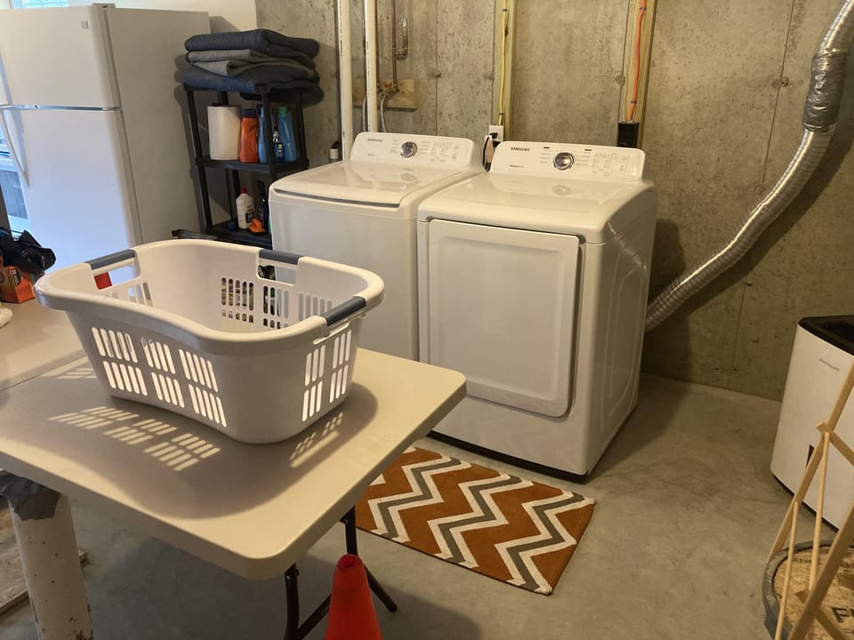 Downstairs washer and dryer with folding table. 