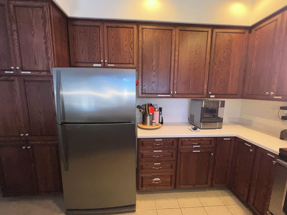 Fully equipped kitchen with modern appliances, cookware and dining essentials.