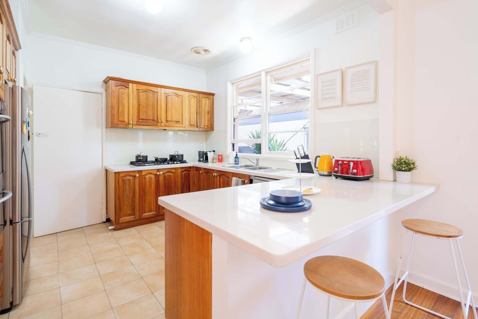 Spacious full equiped open kitchen with back yard view and coffee machine