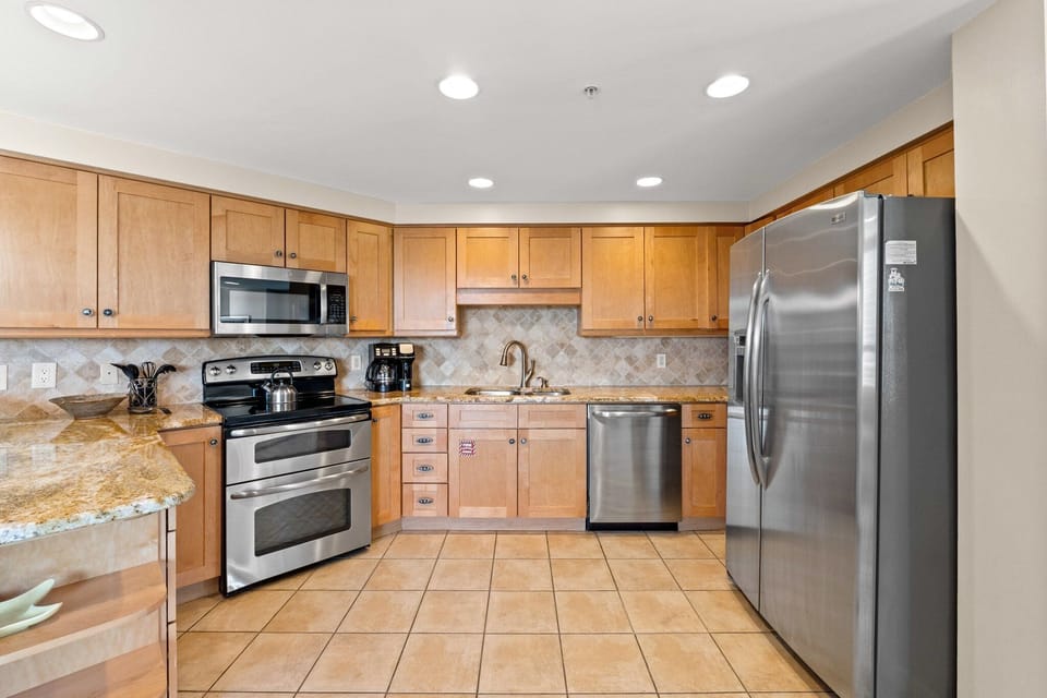 Modern kitchen featuring stainless steel appliances and tile flooring, designed for style and function. Comes with all you need like the comfort of your own kitchen.

Professionally Managed by
Breathe Easy Rentals