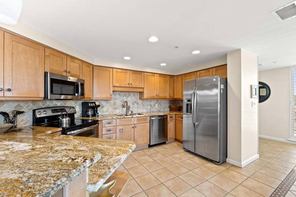 Sleek full kitchen with tile floors and stainless steel appliances, ready for your culinary creations.

Professionally Managed by
Breathe Easy Rentals