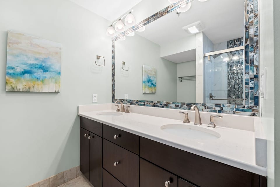 Dual Vanities with large mirror and plenty of storage cabinets and drawers for your personal items.