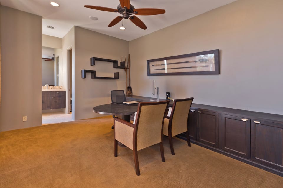 Office with high-speed internet, partner desk, monitor, and en-suite bath. 