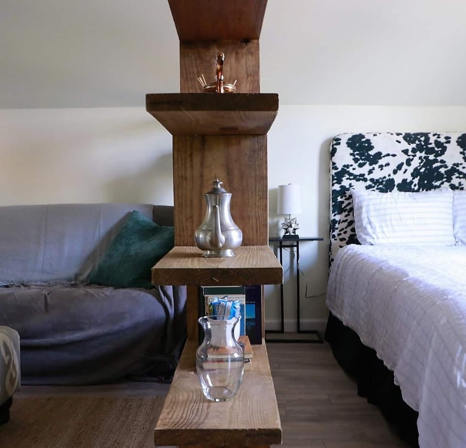 Decor shelf dividing living and sleeping areas