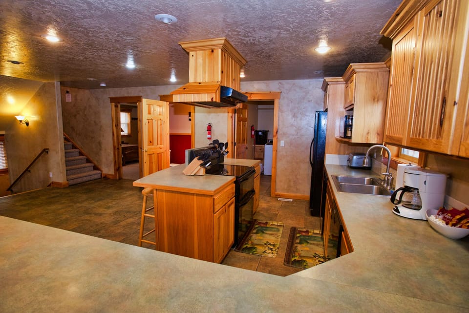 Kitchen looking out to dining room and deck.