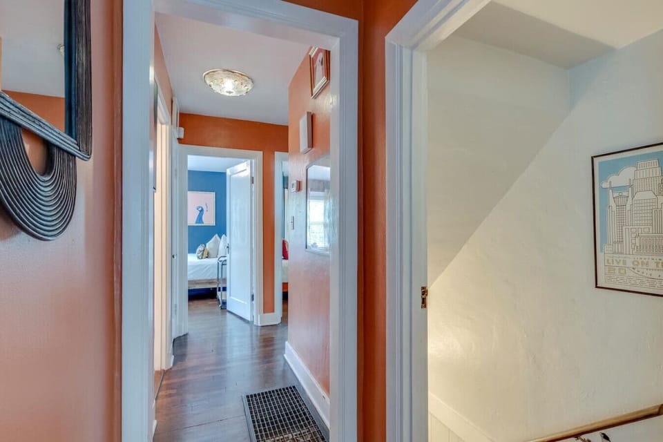 The cozy bedroom with its warm tones and artistic details is a unique and restful space.