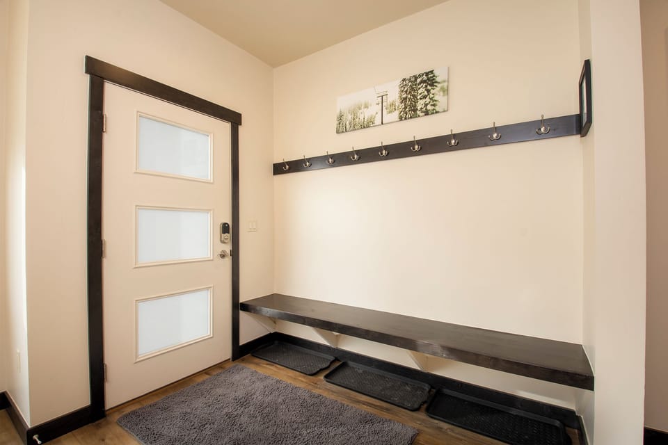 Step into your welcoming mudroom where you'll find convenient built-in seating and coat hooks, perfect for organizing after mountain adventures.