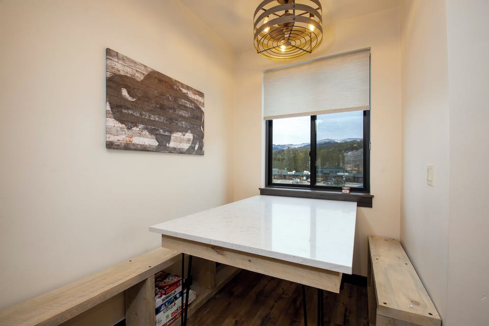 Your cozy breakfast nook features built-in bench seating and mountain views, creating the perfect spot for morning coffee and planning daily adventures.