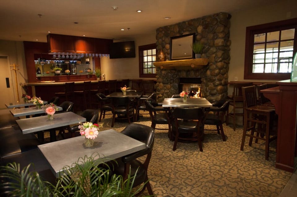 Relax in a cozy lounge with fireplace glow and casual dining