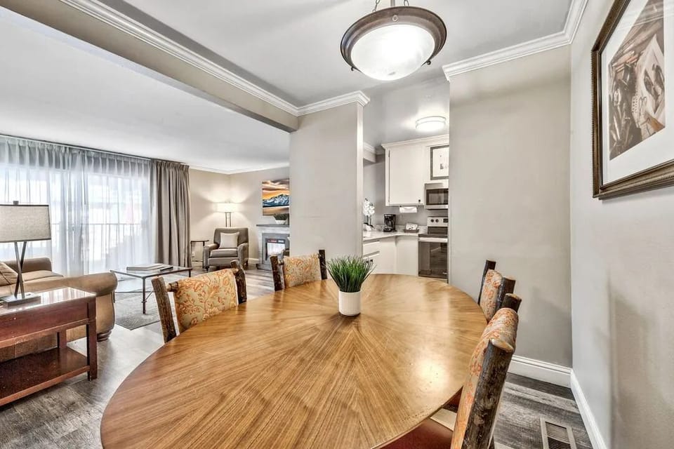 Gather for cozy meals beside a sunlit open-concept living area.