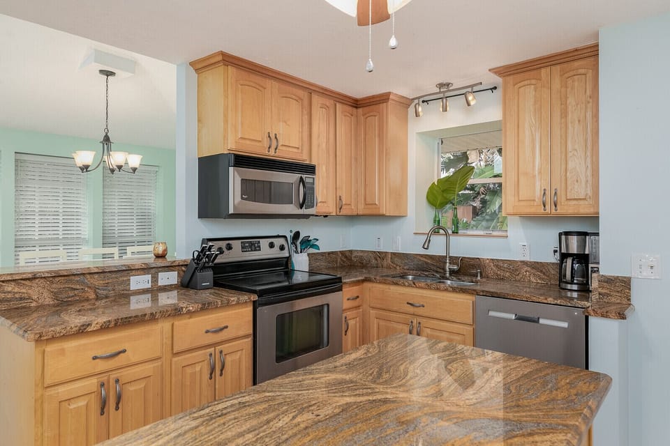 Fully stocked Kitchen with island, stainless steel appliances, etc.