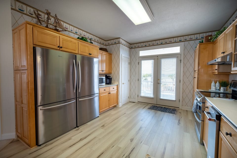 Kitchen with double stainless steel refrigerators and under counter ice maker