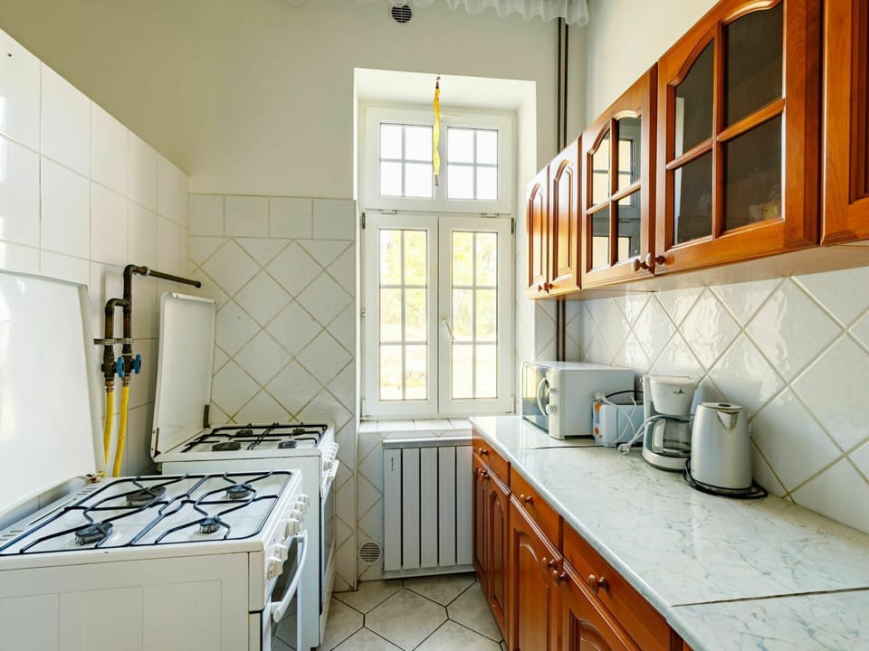Cabinetry, Furniture, Property, Countertop, Kitchen, Kitchen Appliance, Kitchen Stove, Window, Building