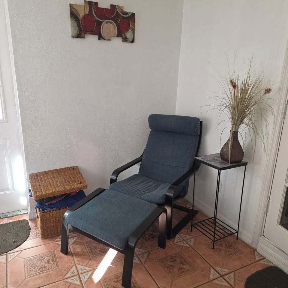 Nice relaxing chair in Florida room, pletty of hot tub or beach towels by  door.