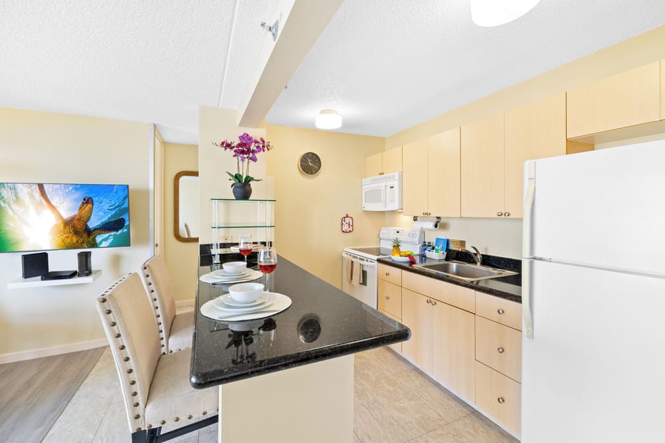 The kitchen countertop has 2 bar stools!
