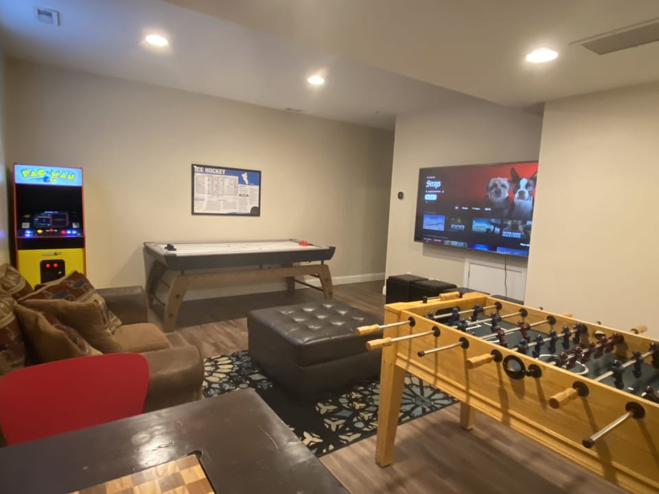 Game room with air hockey, foosball, arcade, chess table and a 75" Smart TV!