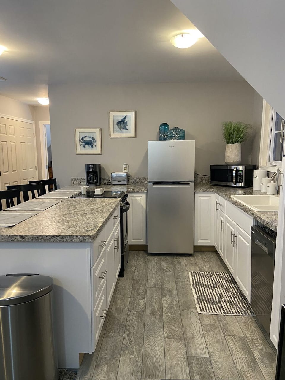 Fully furnished kitchen including refrigerator, ice maker, oven, and dishwasher.