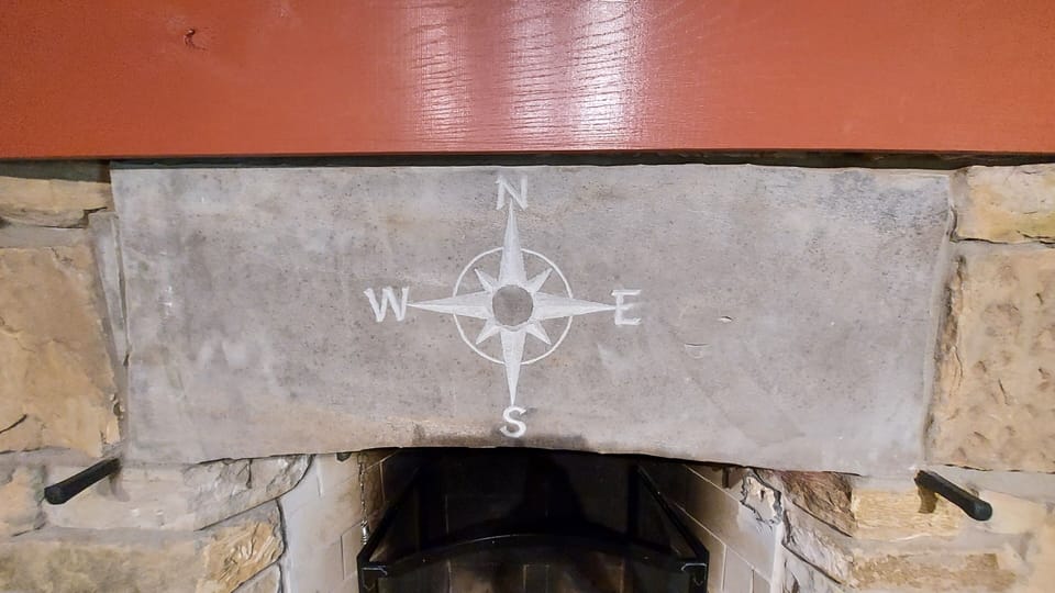 Compass rose fireplace carving.