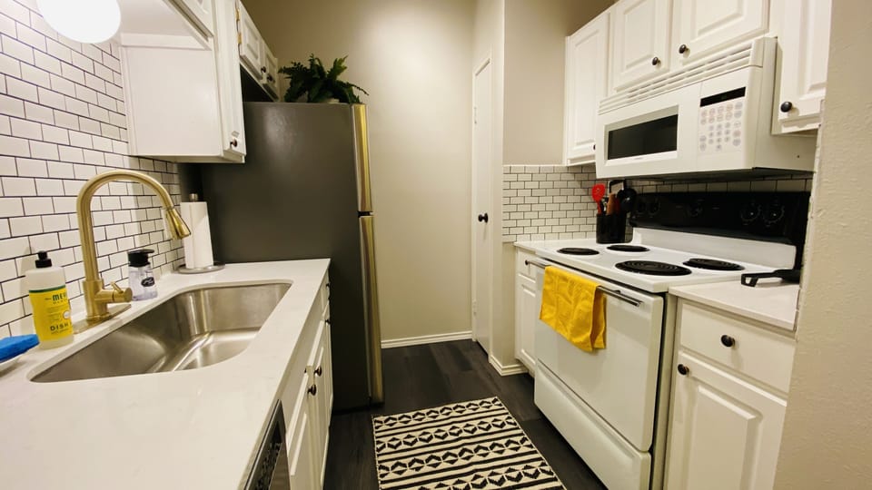 Newly remodeled kitchen with subway tile backsplash and quartz counters