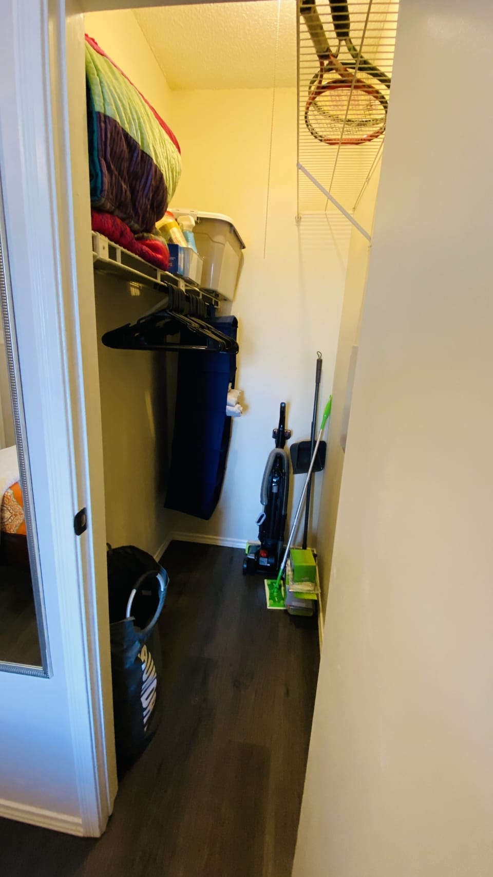 Small walk-in closet with cleaning supplies provided