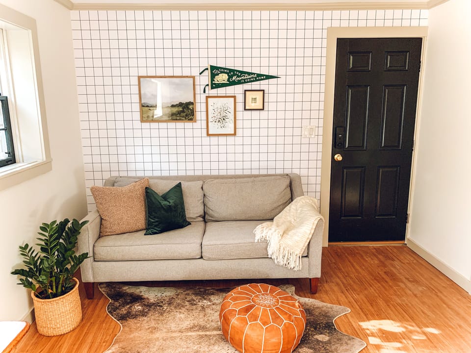 West Elm Loveseat with a view of the television 