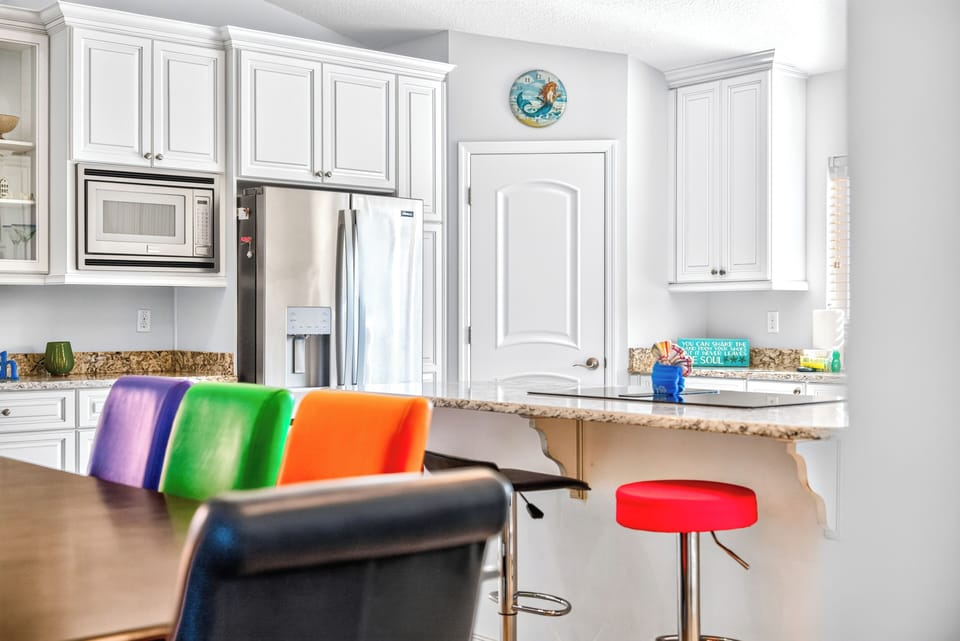 Your fully equipped kitchen invites you to whip up meals at the granite breakfast bar, with stainless-steel appliances and bright white cabinetry creating a clean, cheerful space for gathering.