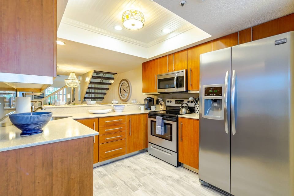 Modern kitchen with solid stone counters and stainless appliances.