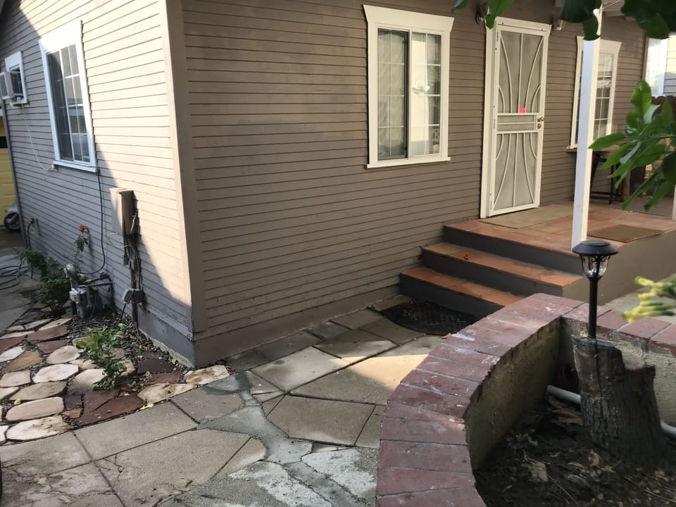The cottage is on the rear of a two house property 