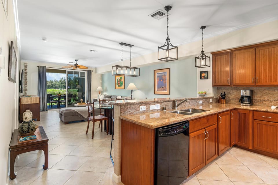 Full kitchen with breakfast bar, granite counters, and modern appliances
