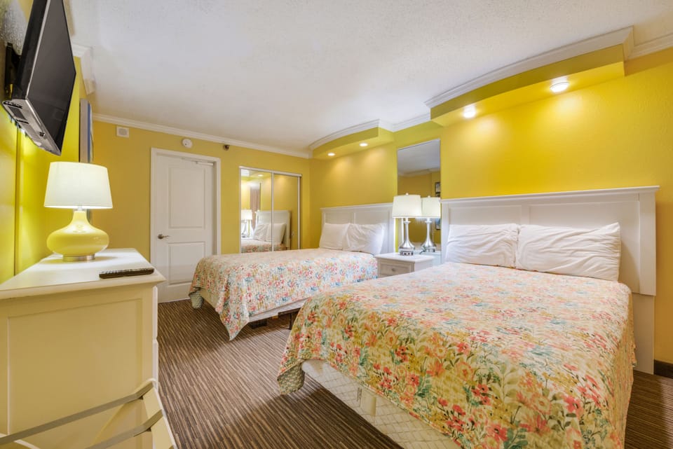 Separate bedroom with two full-sized beds, TV, dresser and closet space...