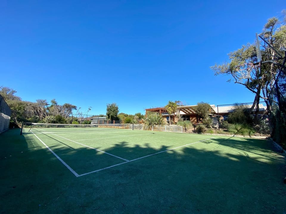 Synthetic tennis court + basketball hoop &  a variety of sports balls to enjoy